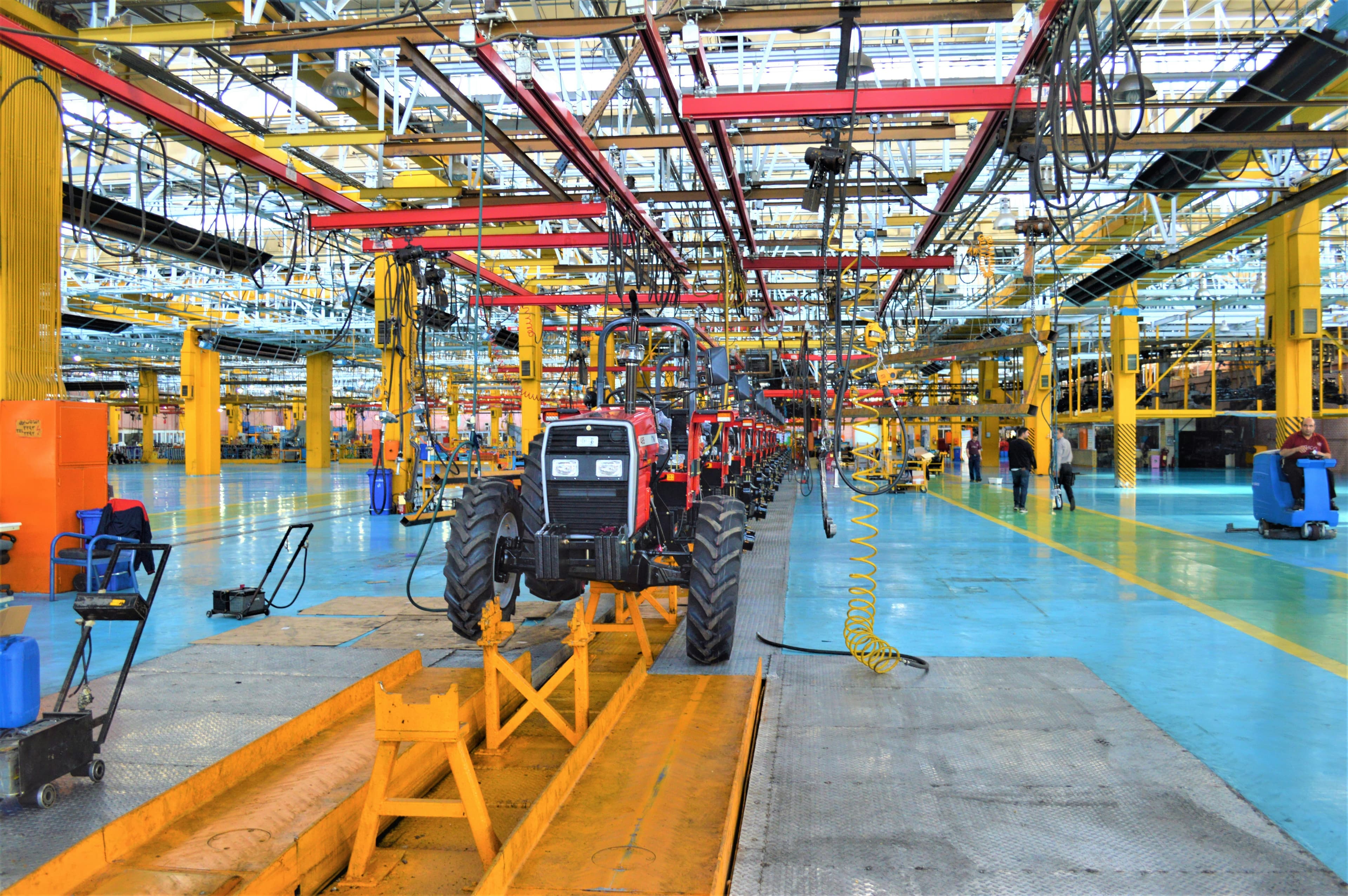 Manufacturing shop floor with workers and industrial equipment